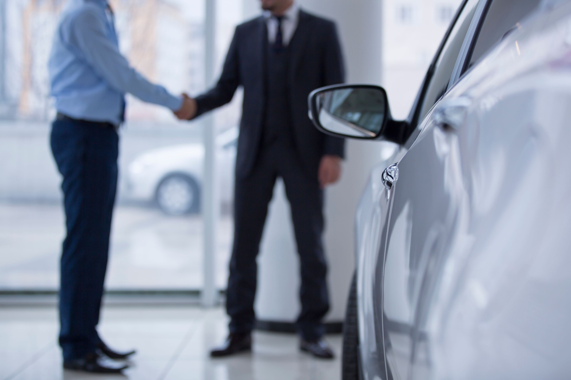 Handshaking in a car showroom